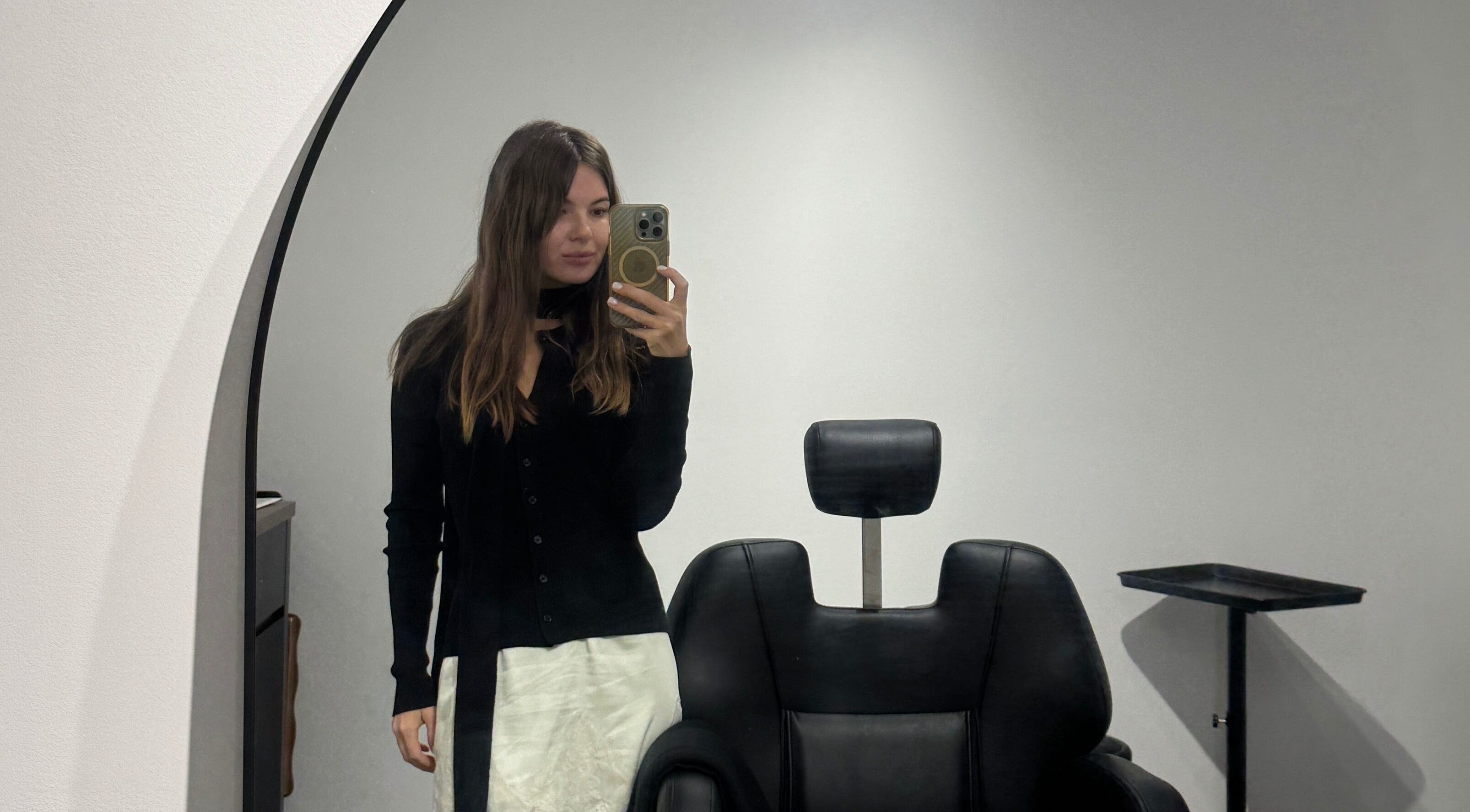 Stylish interior at Beauté Era in Glendale, California, US with a black salon chair and mirror reflection.