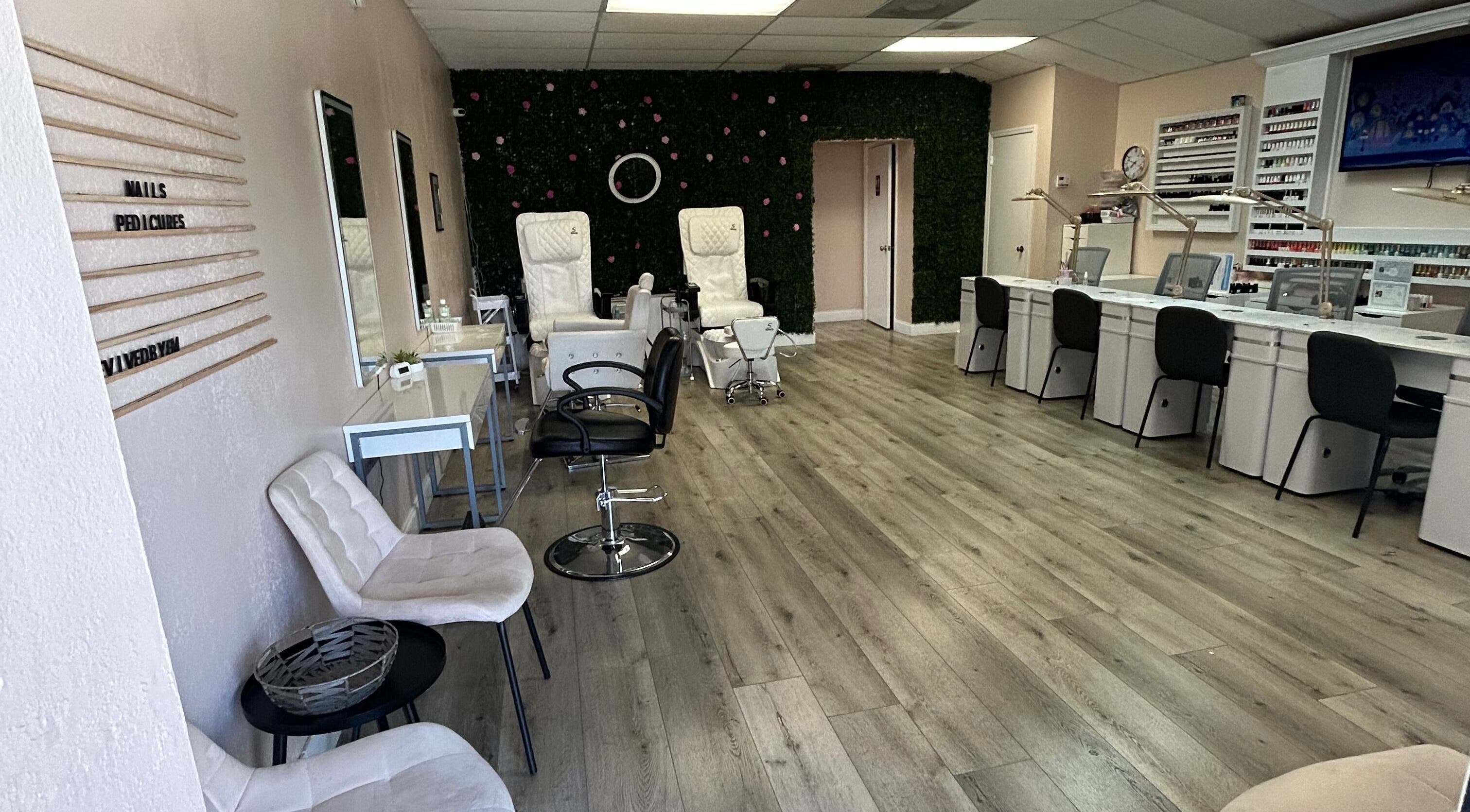 Revived By Emz Llc's stylish nail salon interior in Orlando, Florida, US, featuring white chairs and modern decor.