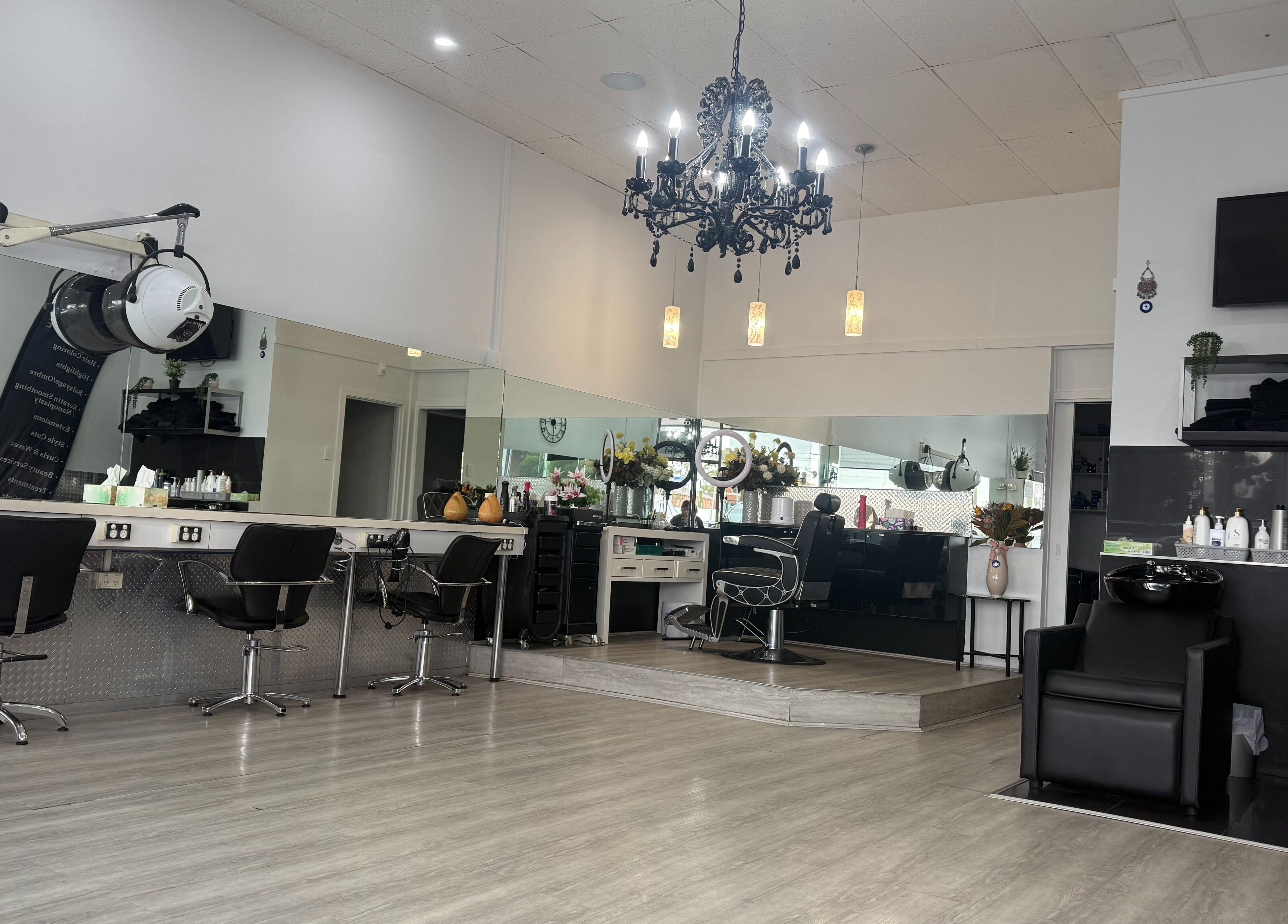 Modern salon interior at Heavenly Hair Lounge, Laverton, Victoria, AU with chic chairs and chandeliers.