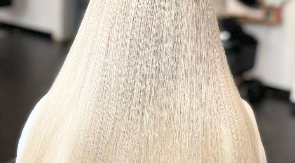 Sleek, silky blonde hair at The Handprint in Roodepoort, Gauteng, ZA, showcasing expert styling.