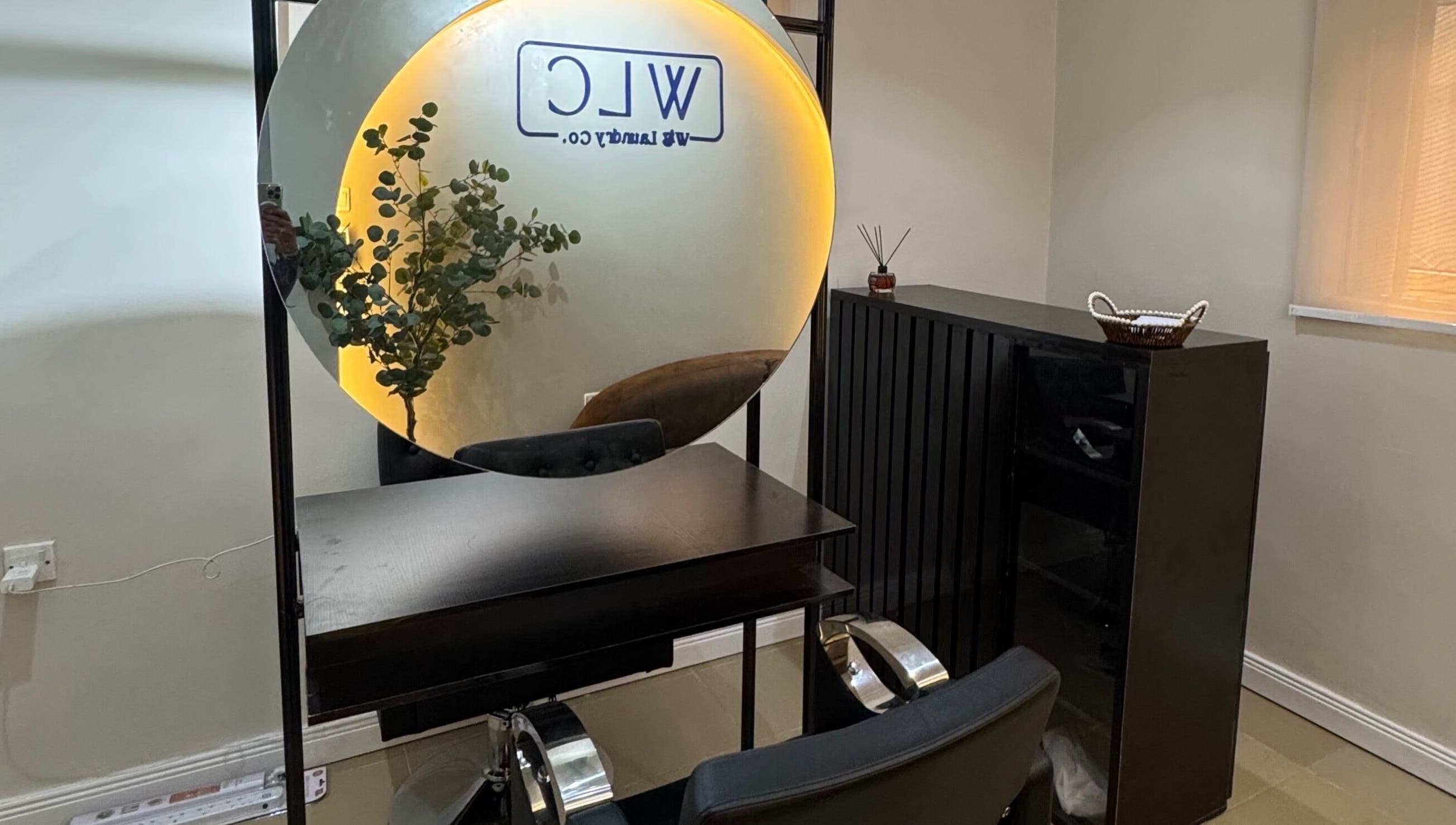 Modern salon setup with mirror and plants at Wig Laundry Company, Lagos, Lagos, NG.