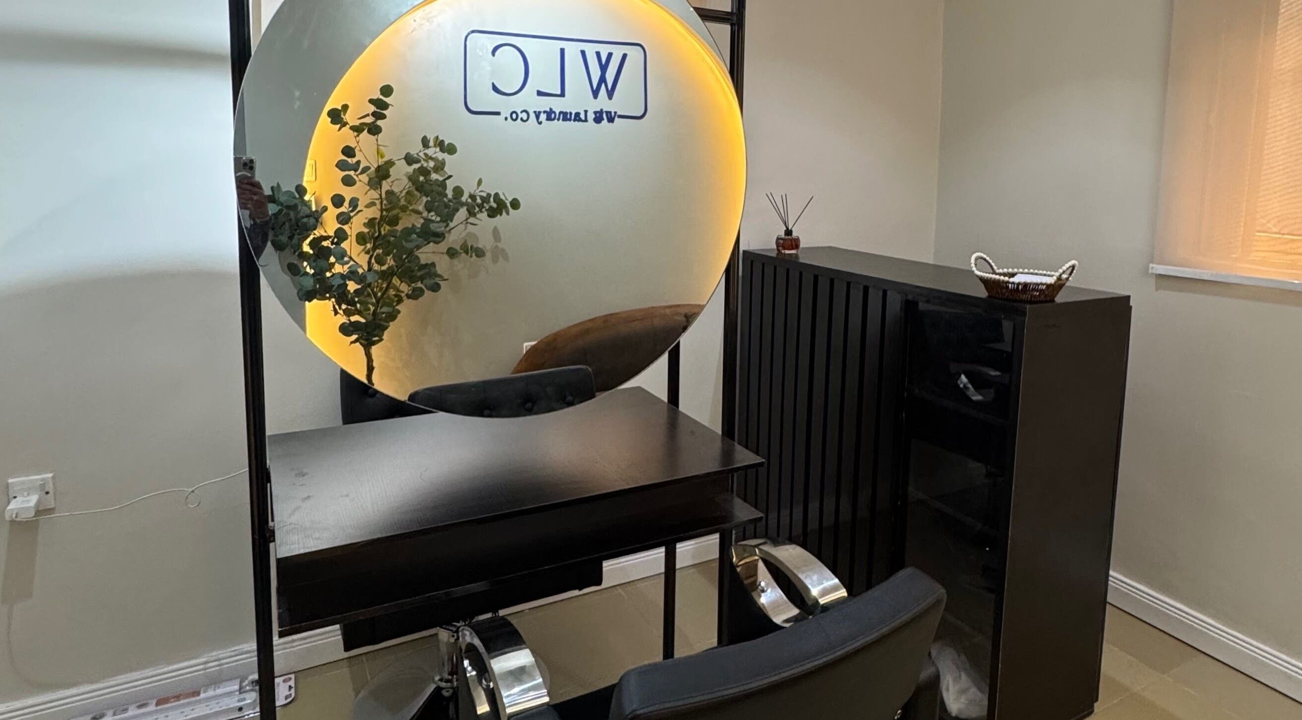 Modern salon setup with mirror and plants at Wig Laundry Company, Lagos, Lagos, NG.