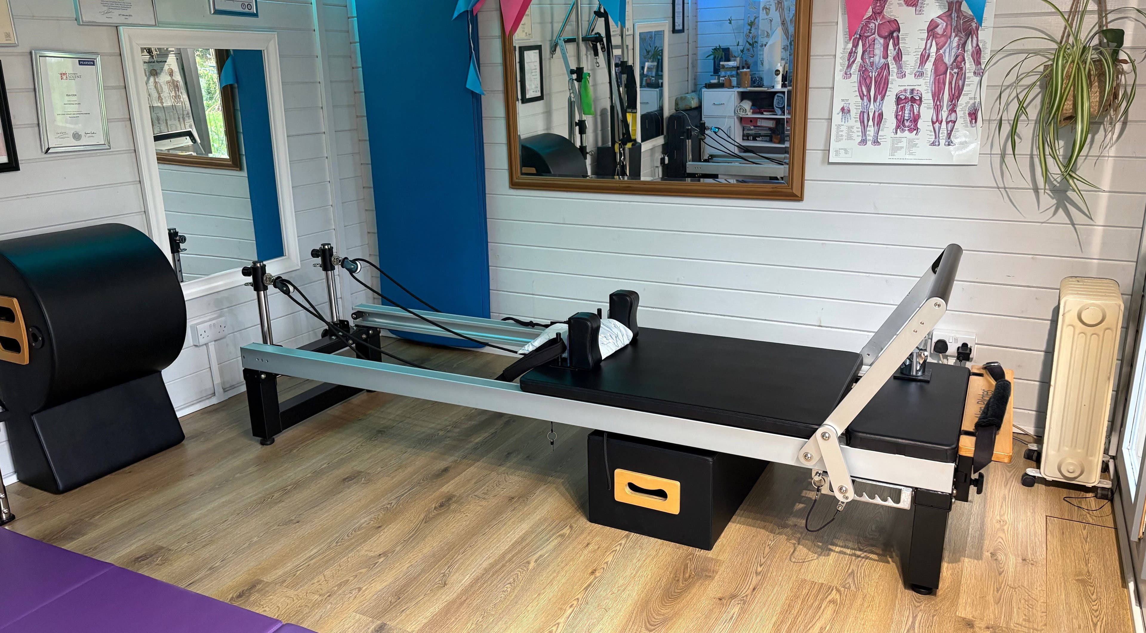 Pilates reformer at IAM Fitness Ltd, Downton, England, GB. A bright, inviting workout room.