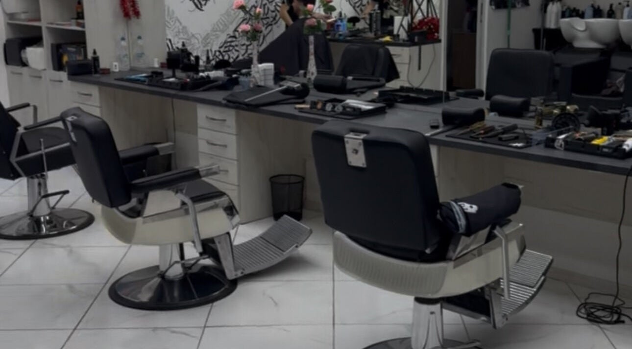 Modern salon setup at Bonnie and Clyde Ruse, Ruse, BG showcasing sleek chairs and styling tools.