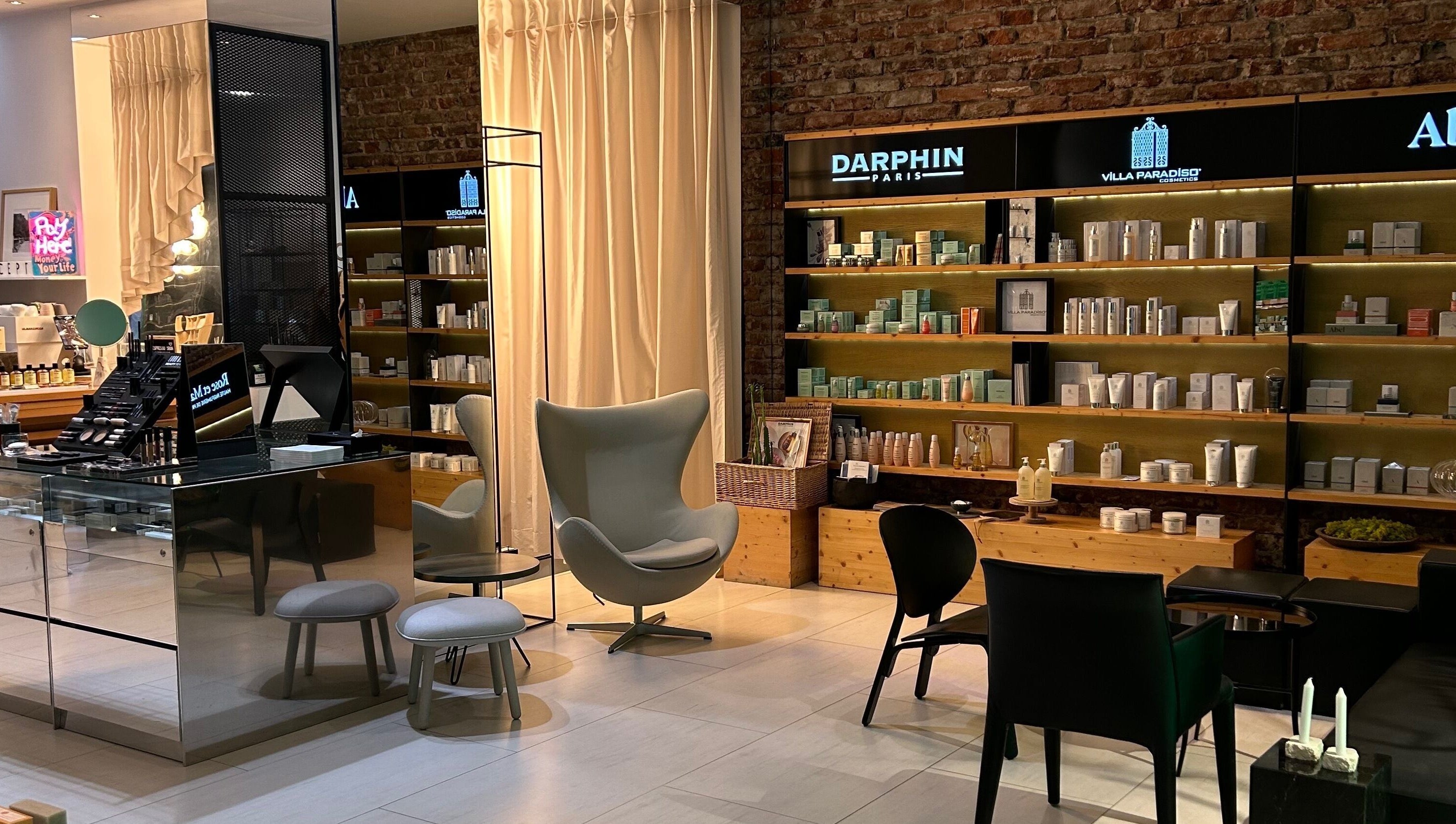 Chic interior of Koncept Beauty in Sofia, Sofia City Province, BG, showcasing luxury beauty products on wooden shelves.