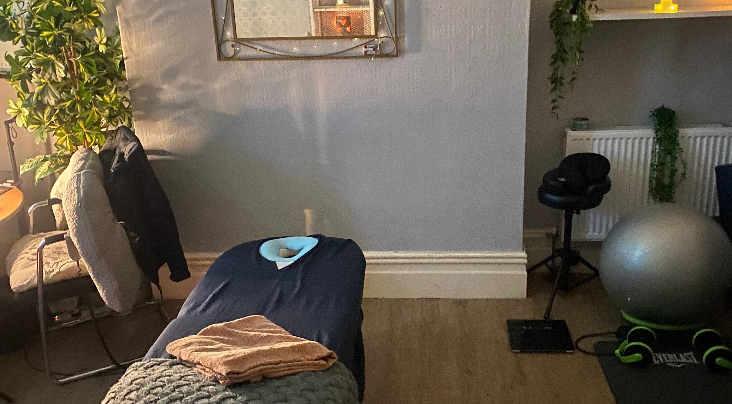 Cozy massage room at 1stclass Massage Sebastopol, Wales, GB with table and soothing decor.