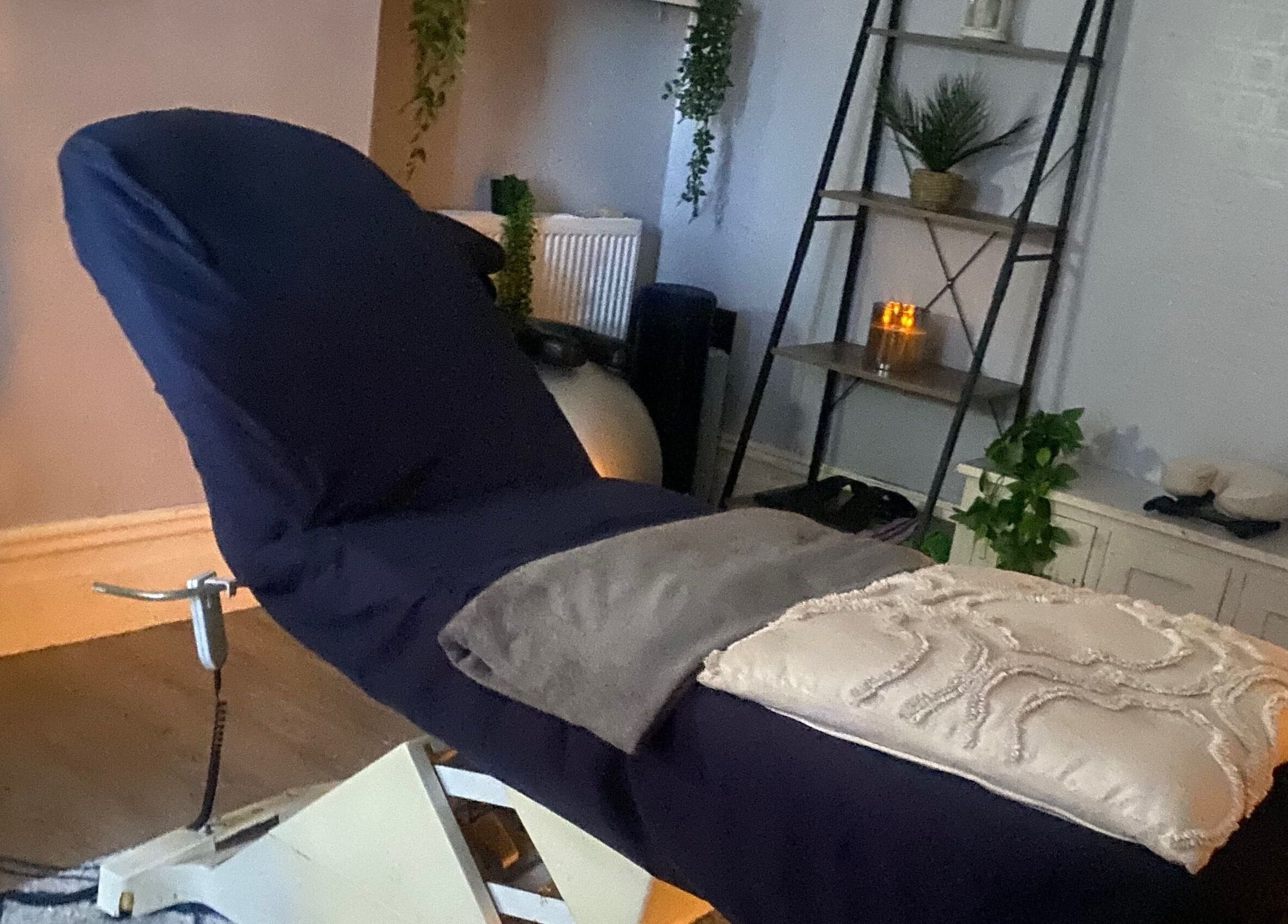 Relaxing massage room setup at 1stclass Massage, Sebastopol, Wales, GB with a comfortable treatment bed.