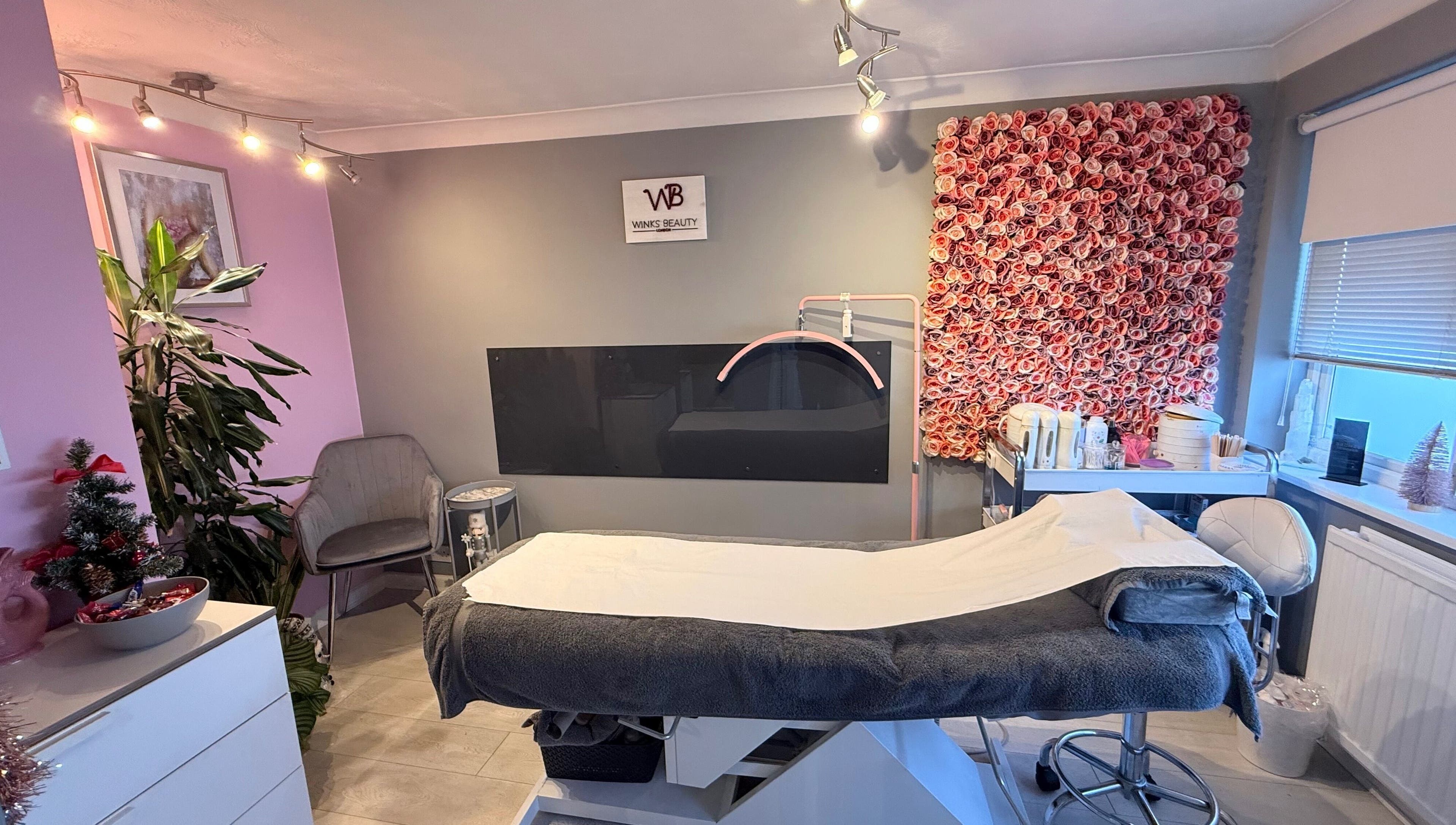 Luxurious treatment room at Winks Beauty London, adorned with floral decor in London, England, GB.