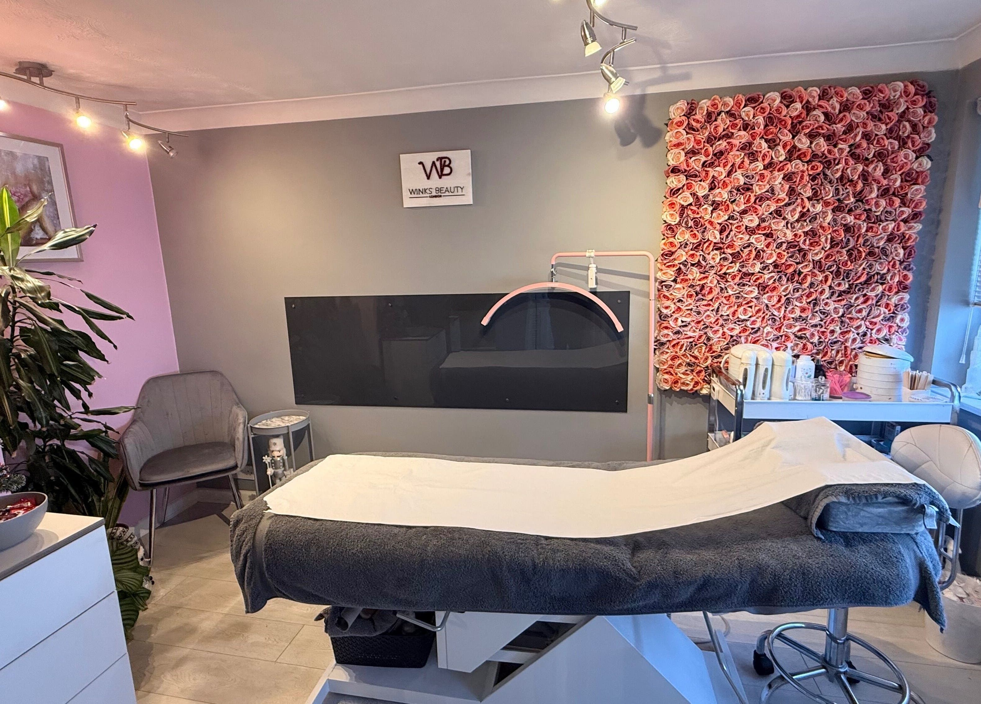 Luxurious treatment room at Winks Beauty London, adorned with floral decor in London, England, GB.
