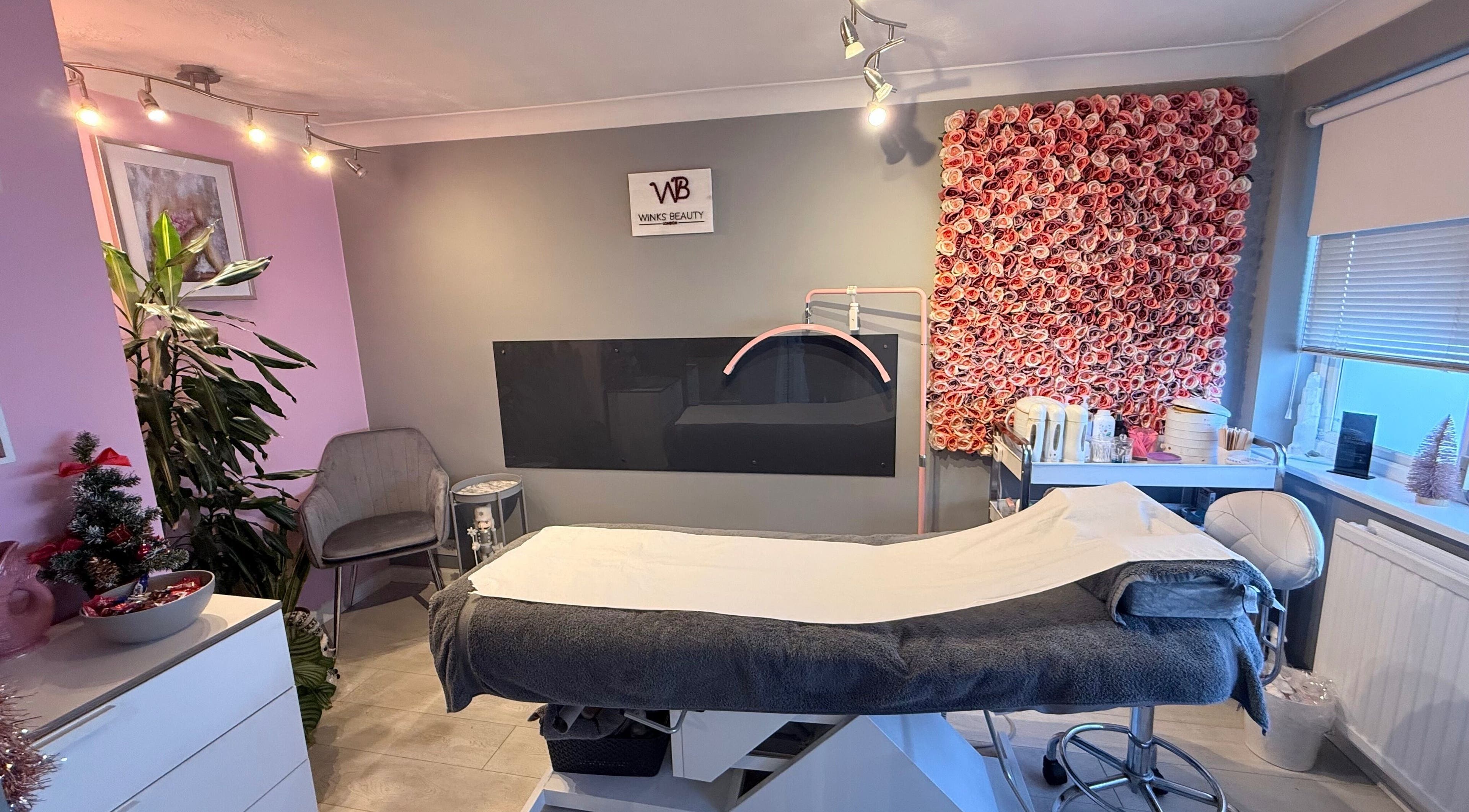 Luxurious treatment room at Winks Beauty London, adorned with floral decor in London, England, GB.