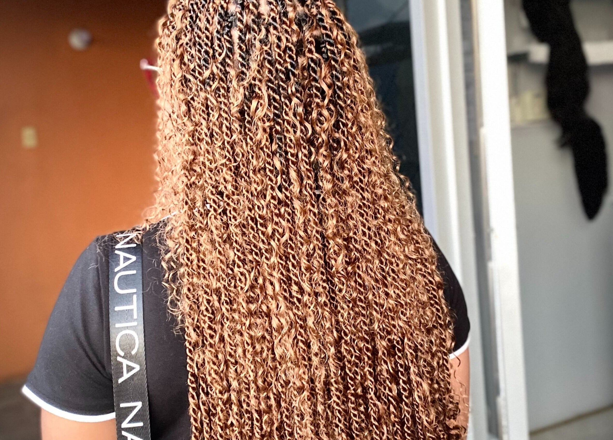 Detailed view of golden braids at Braids by Racquel in Mandeville, Manchester Parish, JM.