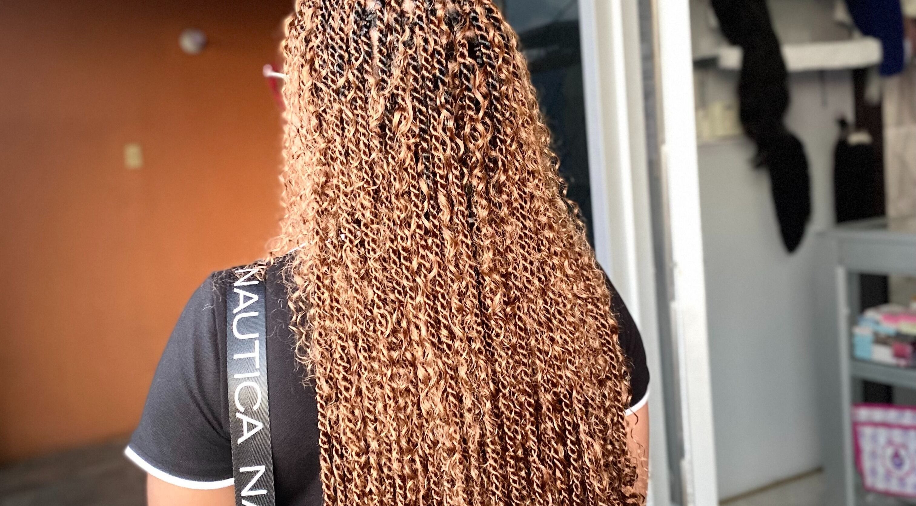 Detailed view of golden braids at Braids by Racquel in Mandeville, Manchester Parish, JM.