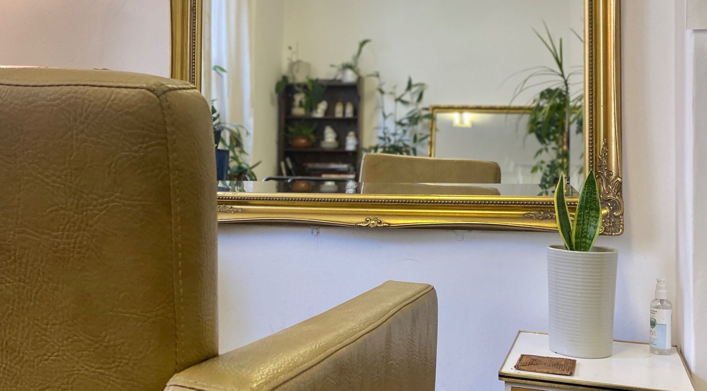 Elegant salon mirror and chair at Do-Lalli hair, London, England, GB with plants and serene decor.