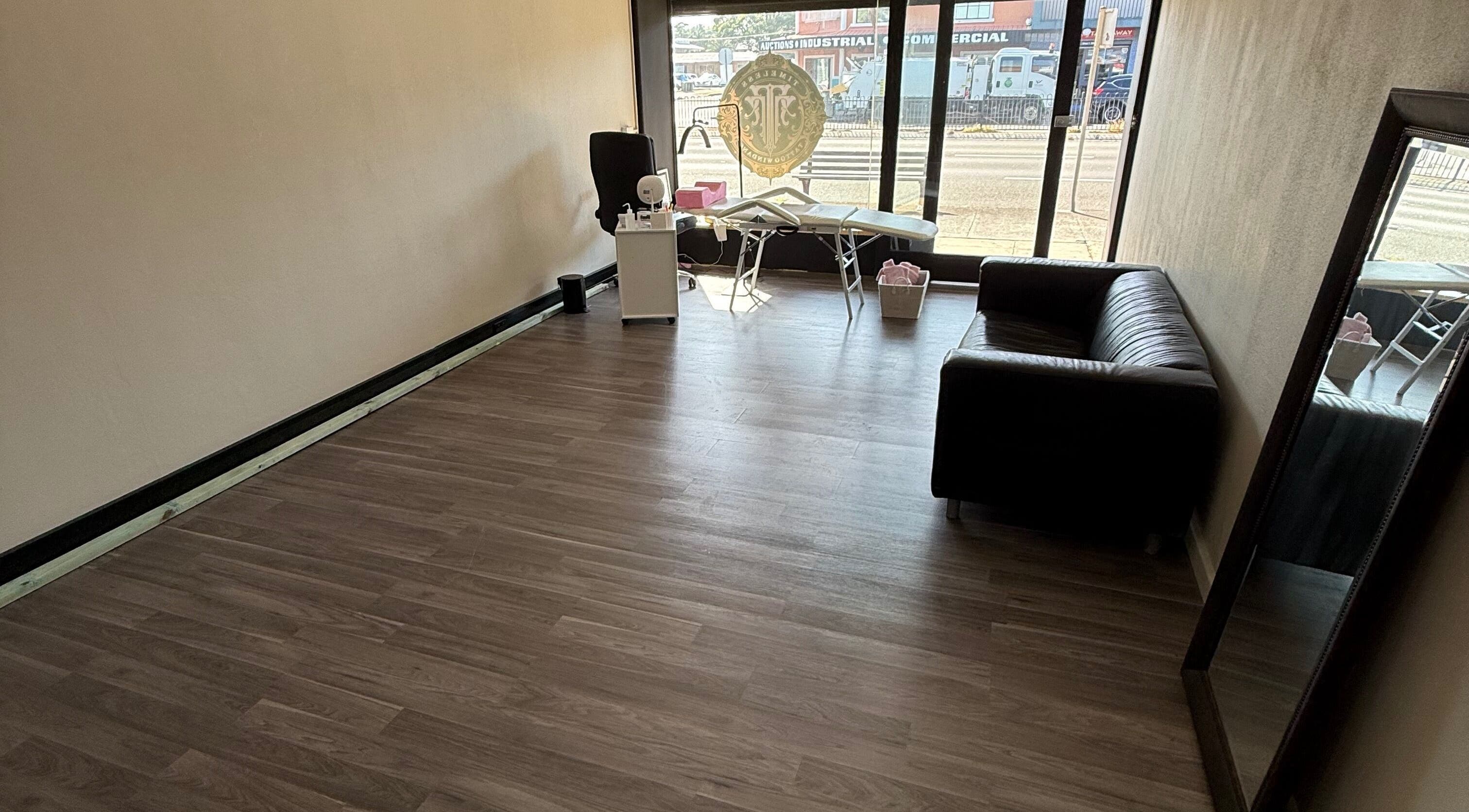 Spacious interior of Lush Beauty Haus in Windang, New South Wales, AU featuring wooden floors and modern furnishings.
