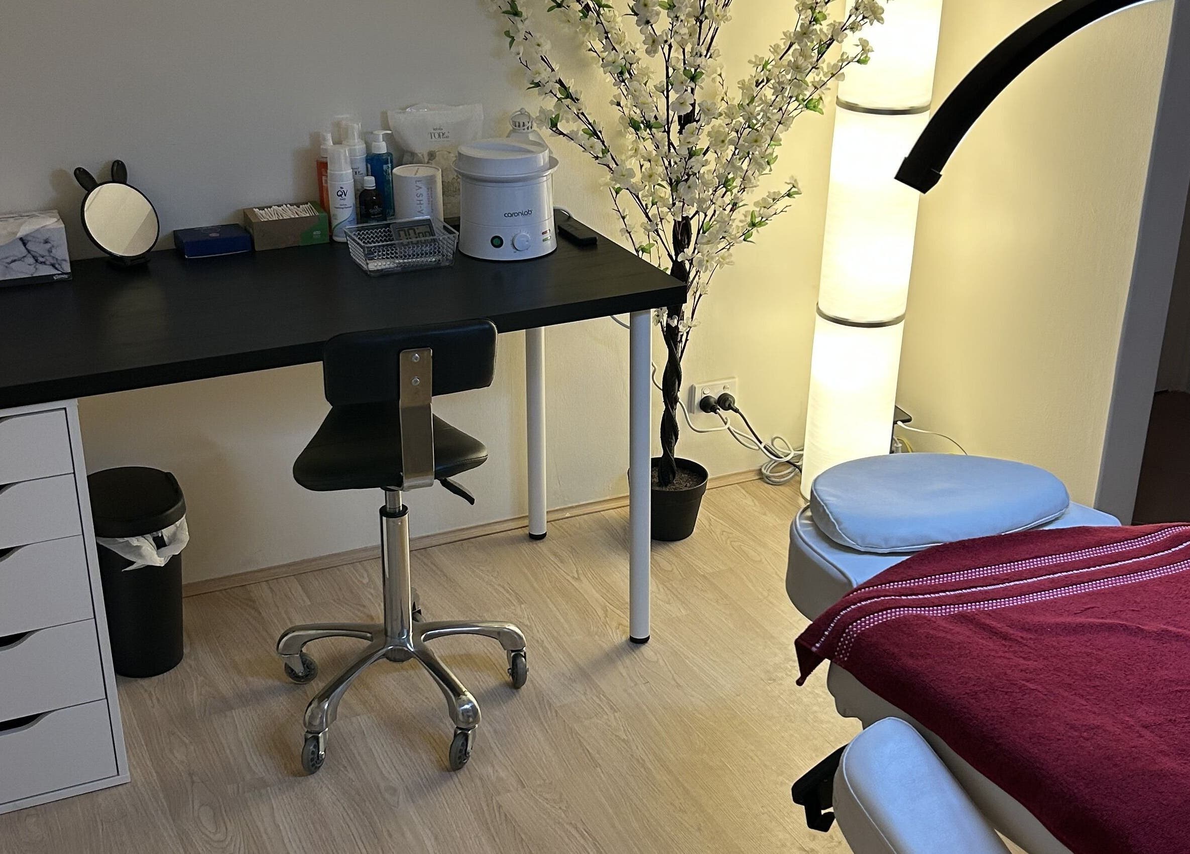 Treatment room at Velvet Touch Brows, Kinross, Western Australia, AU with massage table and floral decor.
