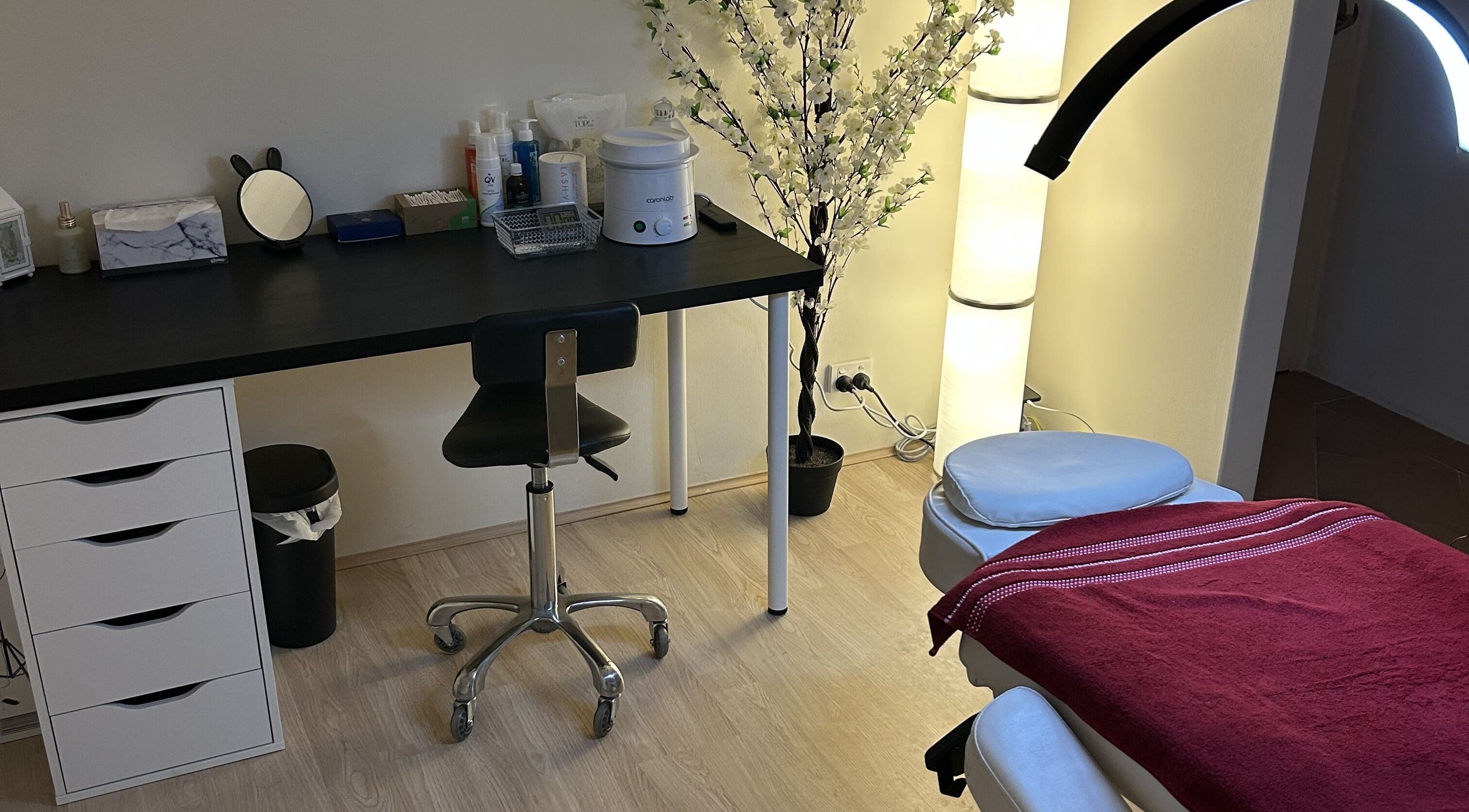 Treatment room at Velvet Touch Brows, Kinross, Western Australia, AU with massage table and floral decor.