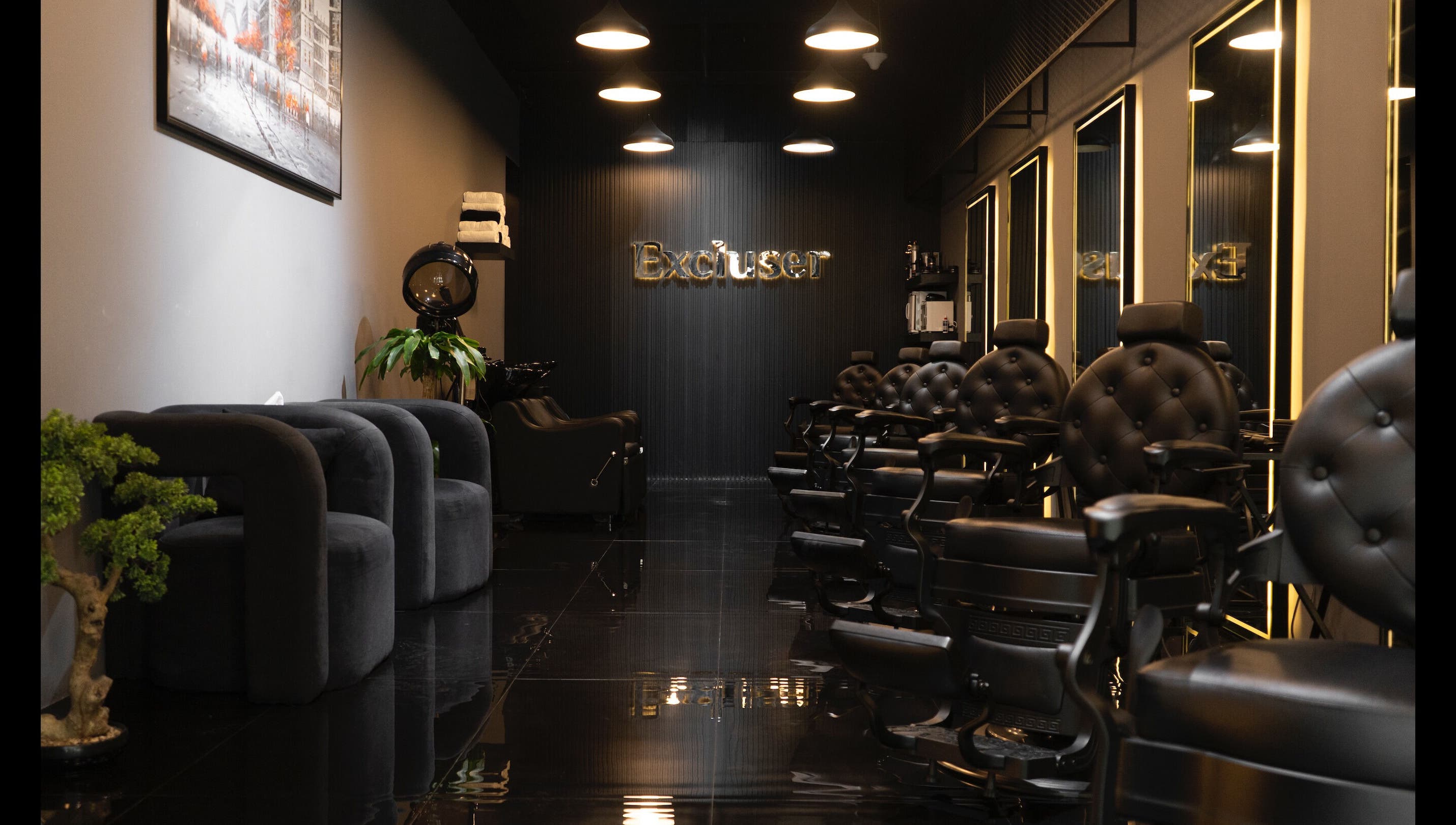 Modern interior of Excluser Gents Salon L.L.C in Dubai, AE featuring elegant black chairs and stylish decor.