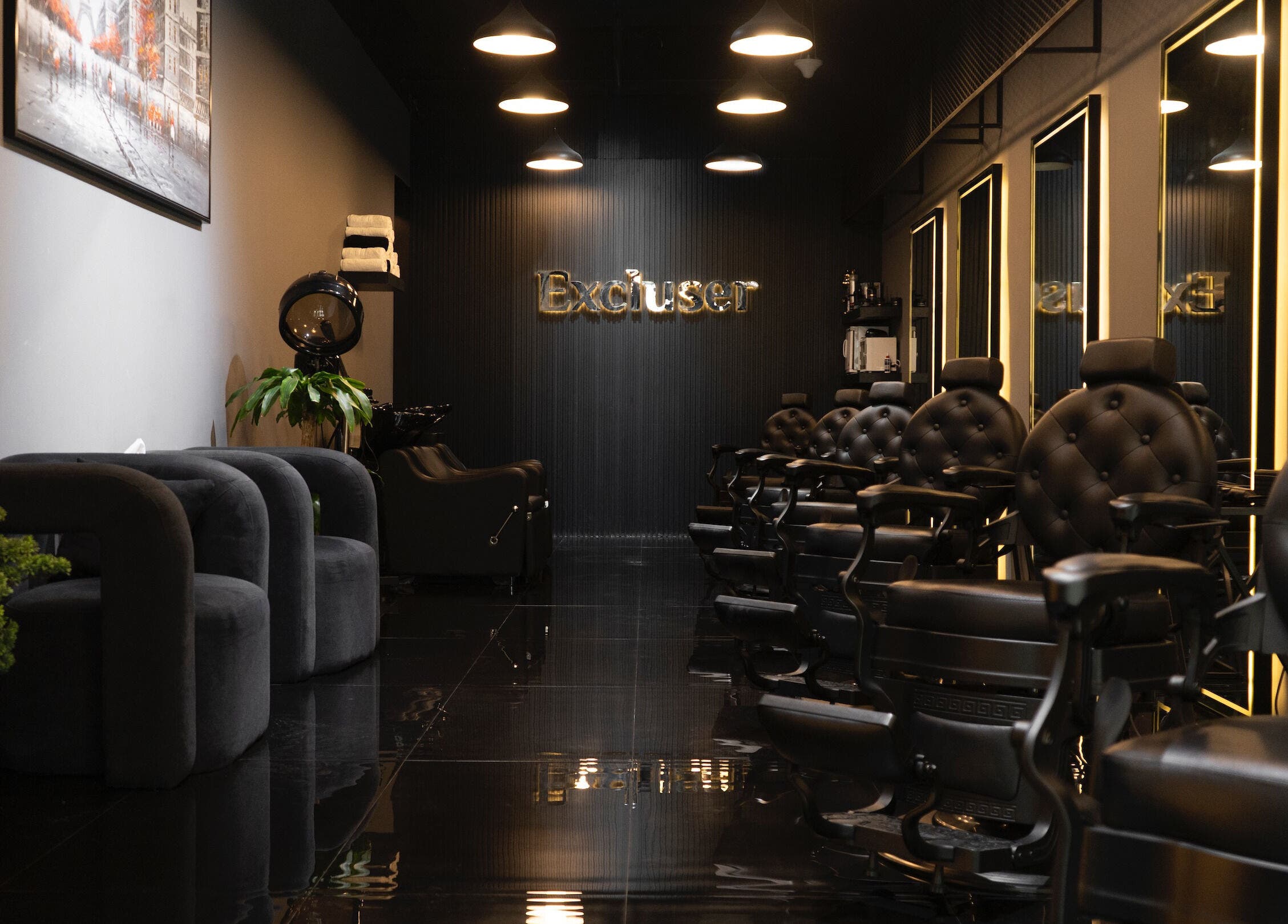 Modern interior of Excluser Gents Salon L.L.C in Dubai, AE featuring elegant black chairs and stylish decor.