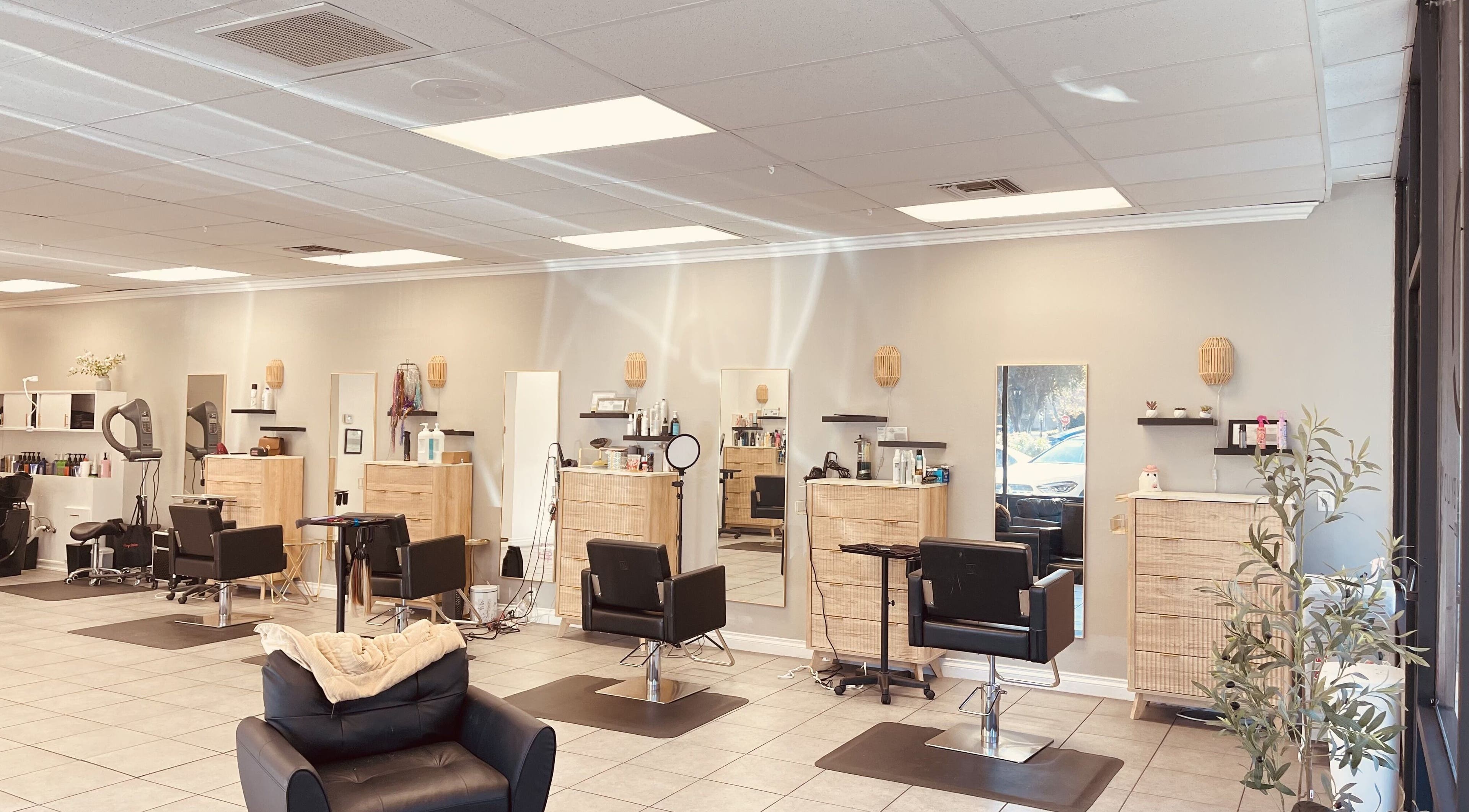 Inviting interior of Hair By Vilen in Santa Clarita, California, US, featuring modern styling stations and warm decor.