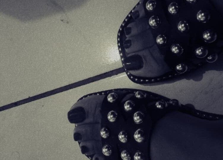 Stylish studded sandals on tiled floor at The Basic, Pretoria, Gauteng, ZA, highlighting fashion and elegance.