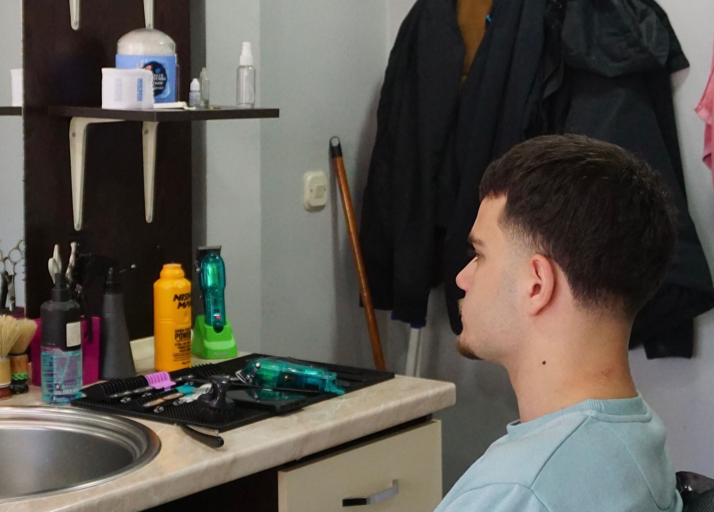 Gentleman enjoying a haircut at Studio Kral, Ohrid, Municipality Of Ohrid, MK.