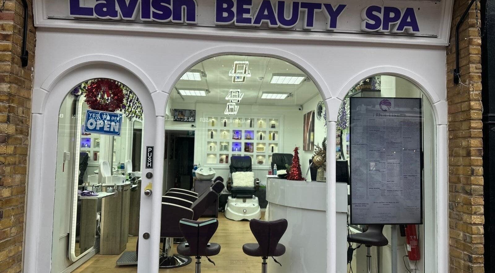 Entrance of Lavish Beauty Spa in London, England, GB showing elegant interior decor and salon chairs.