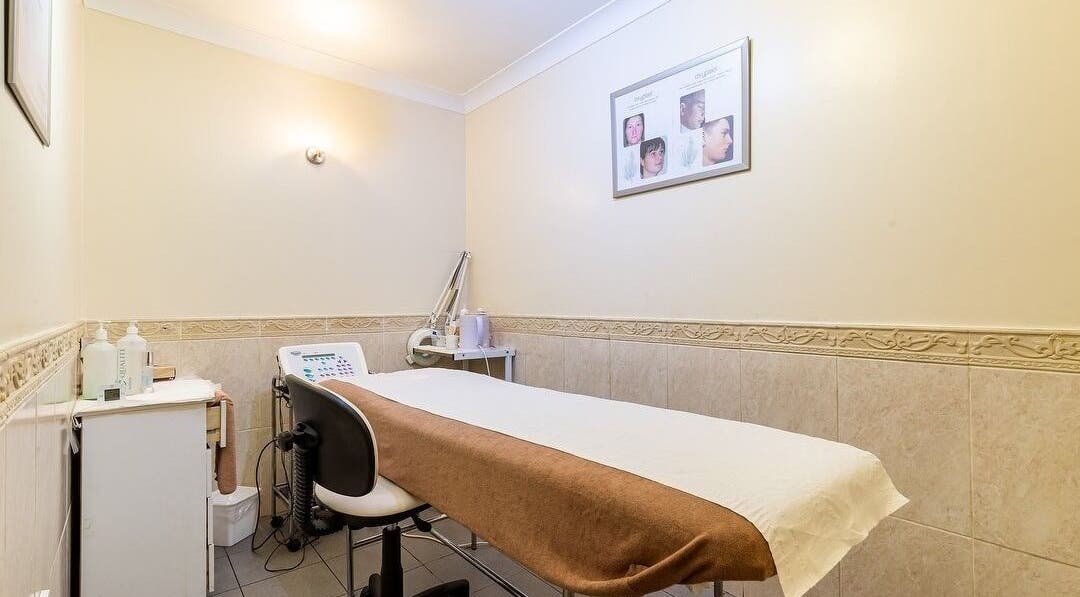 Cozy treatment room at Elite Cosmetology, London, England, GB with a massage bed and skincare equipment.