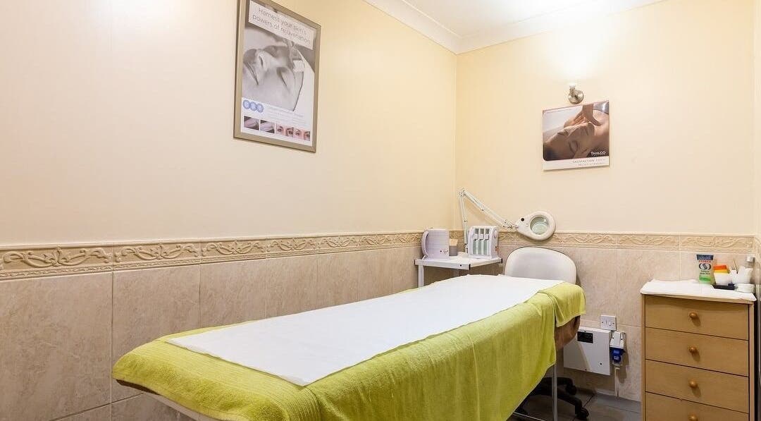 Calm treatment room at Elite Cosmetology, London, England, GB, featuring a treatment bed and equipment.