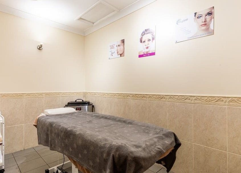Cozy treatment room at Elite Cosmetology in London, England, GB with a massage table and soothing decor.