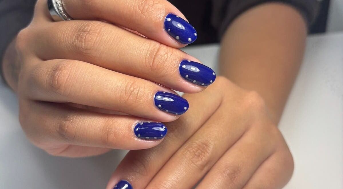 Stylish blue nail art at Nails with Liuda, Windsor, Ontario, CA, showcasing expert care and design.