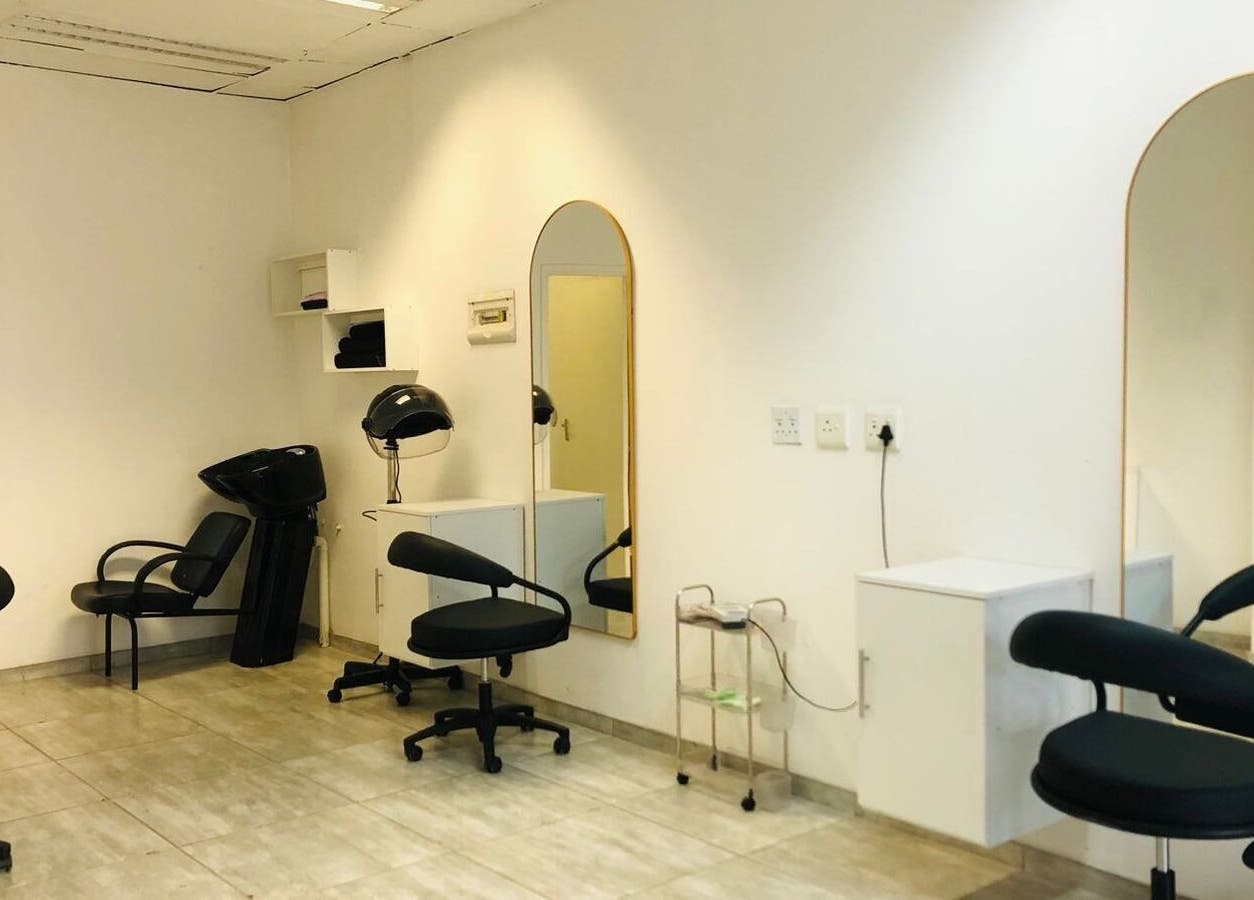 Chic interior of Glamour Groove Hair Lounge, Johannesburg, Gauteng, ZA, featuring modern salon chairs and mirrors.