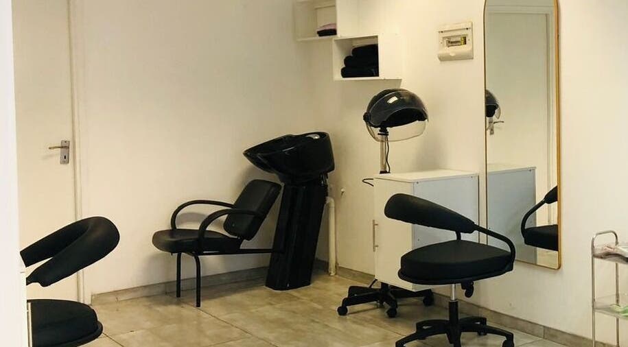 Stylish interior of Glamour Groove Hair Lounge in Johannesburg, Gauteng, ZA with salon chairs and mirrors.