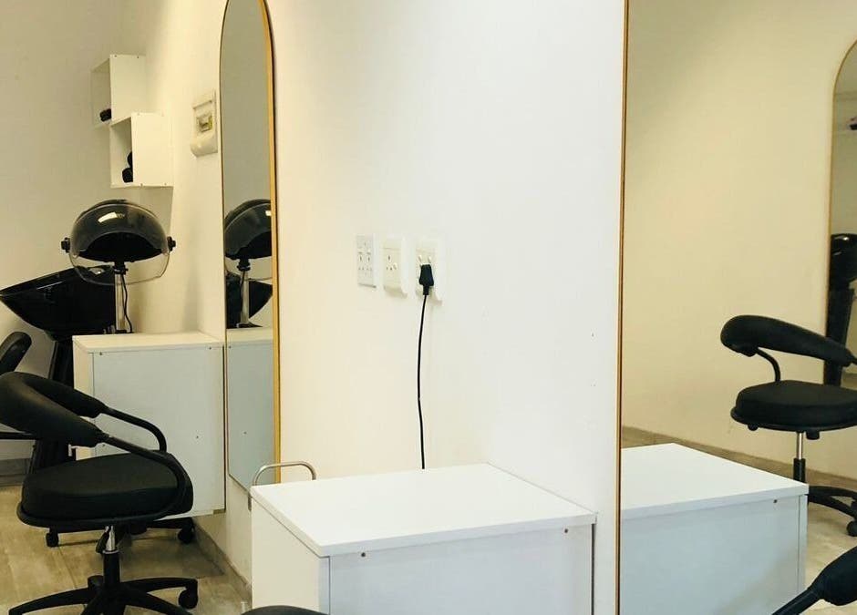 Modern salon interior at Glamour Groove Hair Lounge, Johannesburg, Gauteng, ZA featuring stylish chairs and mirrors.