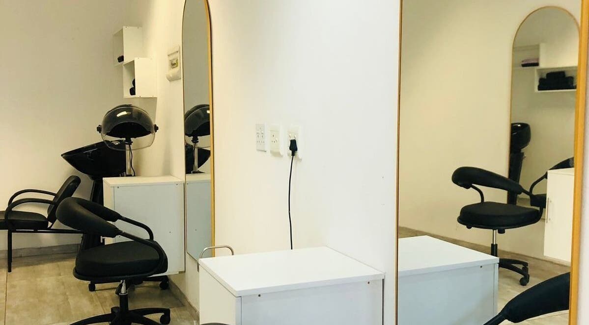 Modern salon interior at Glamour Groove Hair Lounge, Johannesburg, Gauteng, ZA featuring stylish chairs and mirrors.