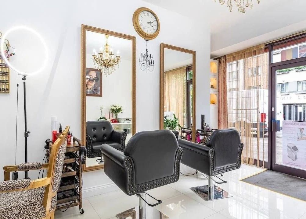Elegant salon chairs and mirrors at TT Hair And Beauty Academy, London, England, GB with modern decor.