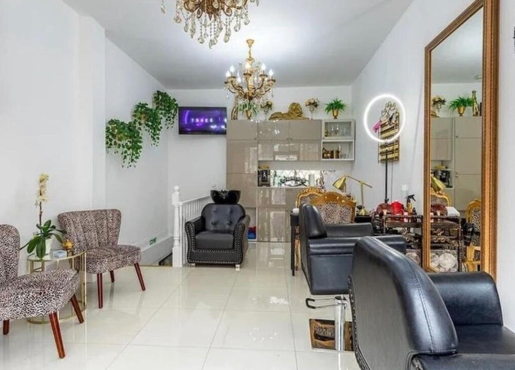 Chic interior of TT Hair And Beauty Academy in London, England, GB with stylish seating and decor.