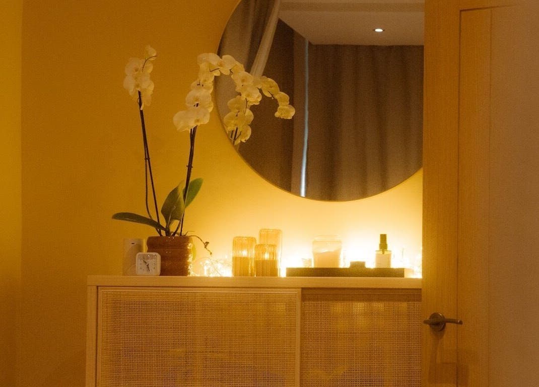Warm and inviting decor at Roukh Thai Wellness Prestwich, Manchester, England, GB with orchids and ambient lighting.