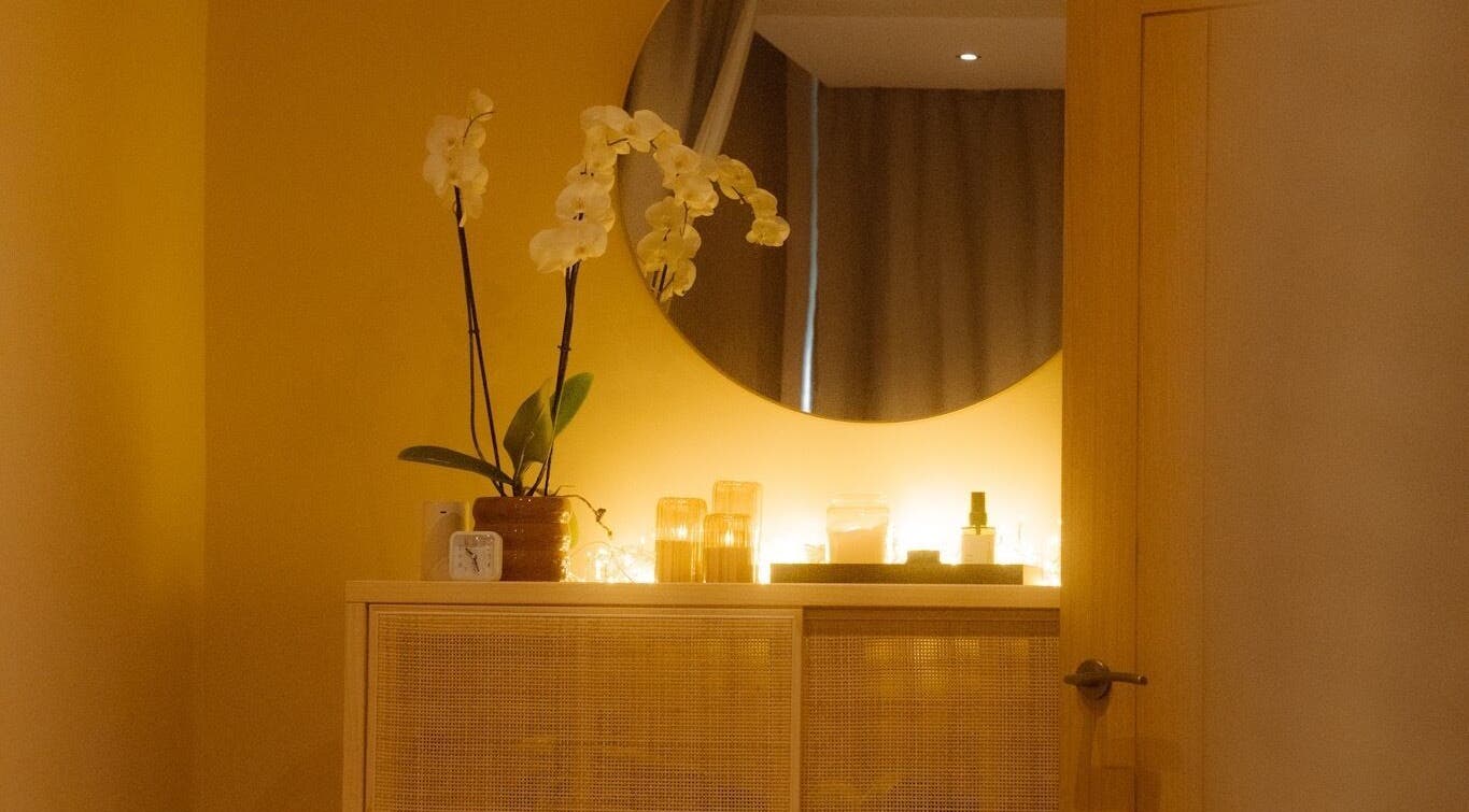 Warm and inviting decor at Roukh Thai Wellness Prestwich, Manchester, England, GB with orchids and ambient lighting.