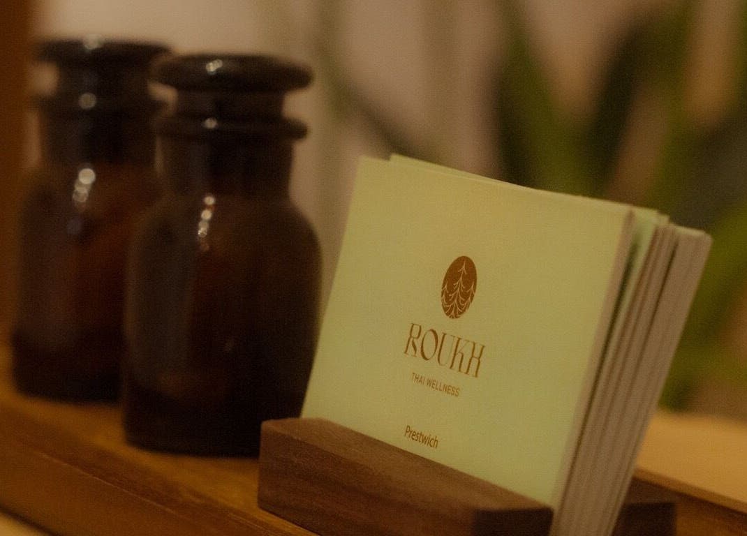 Roukh Thai Wellness Prestwich cards on a wooden stand in Manchester, England, GB.