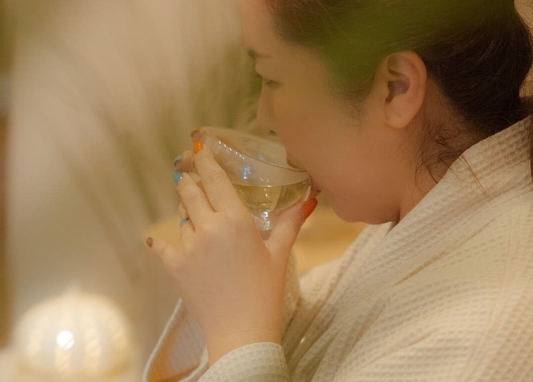 Guest enjoying herbal tea at Roukh Thai Wellness Prestwich, Manchester, England, GB for relaxation.