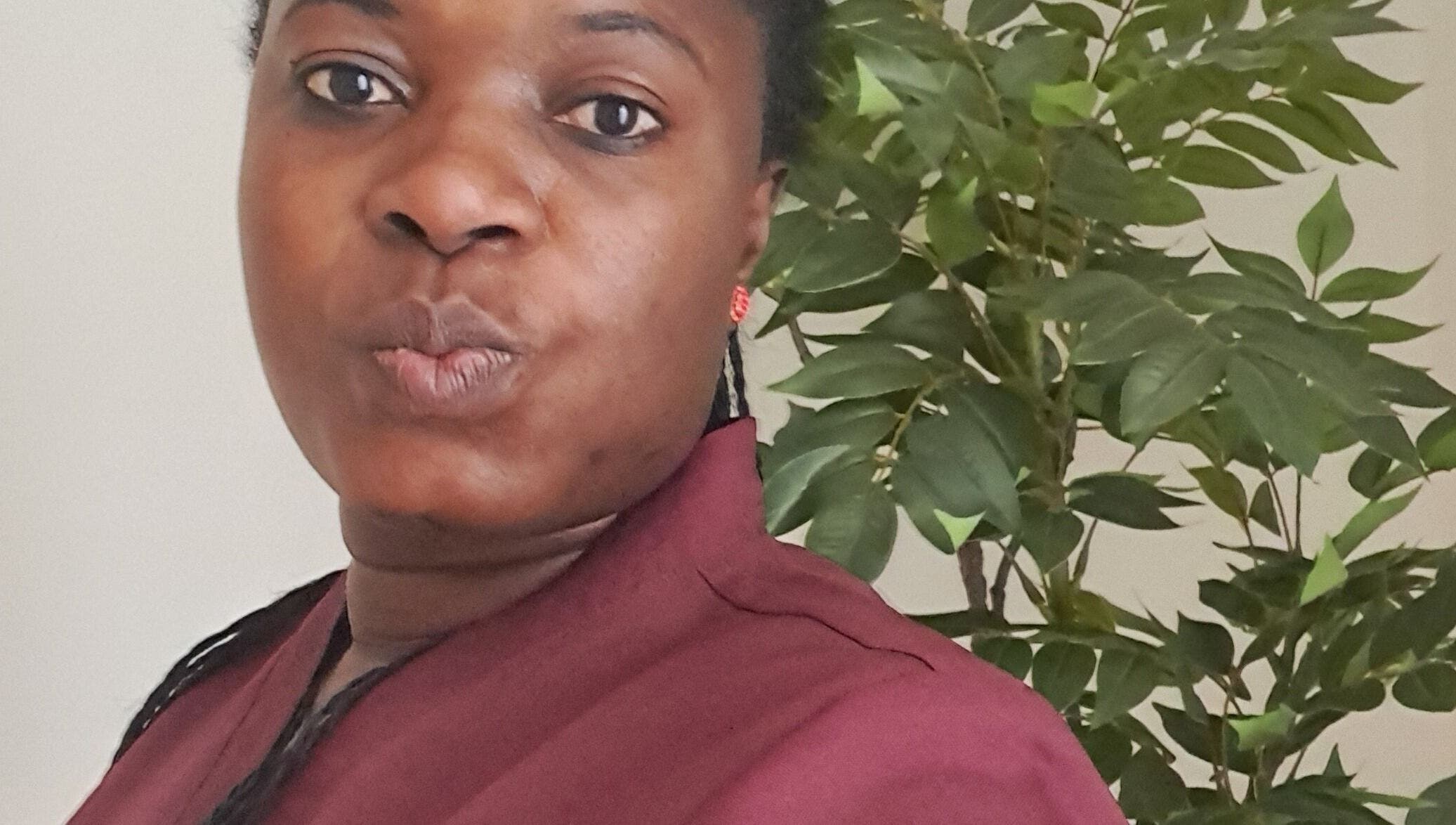 Therapist at Mariam Massage poses with natural backdrop in Muscat, OM.