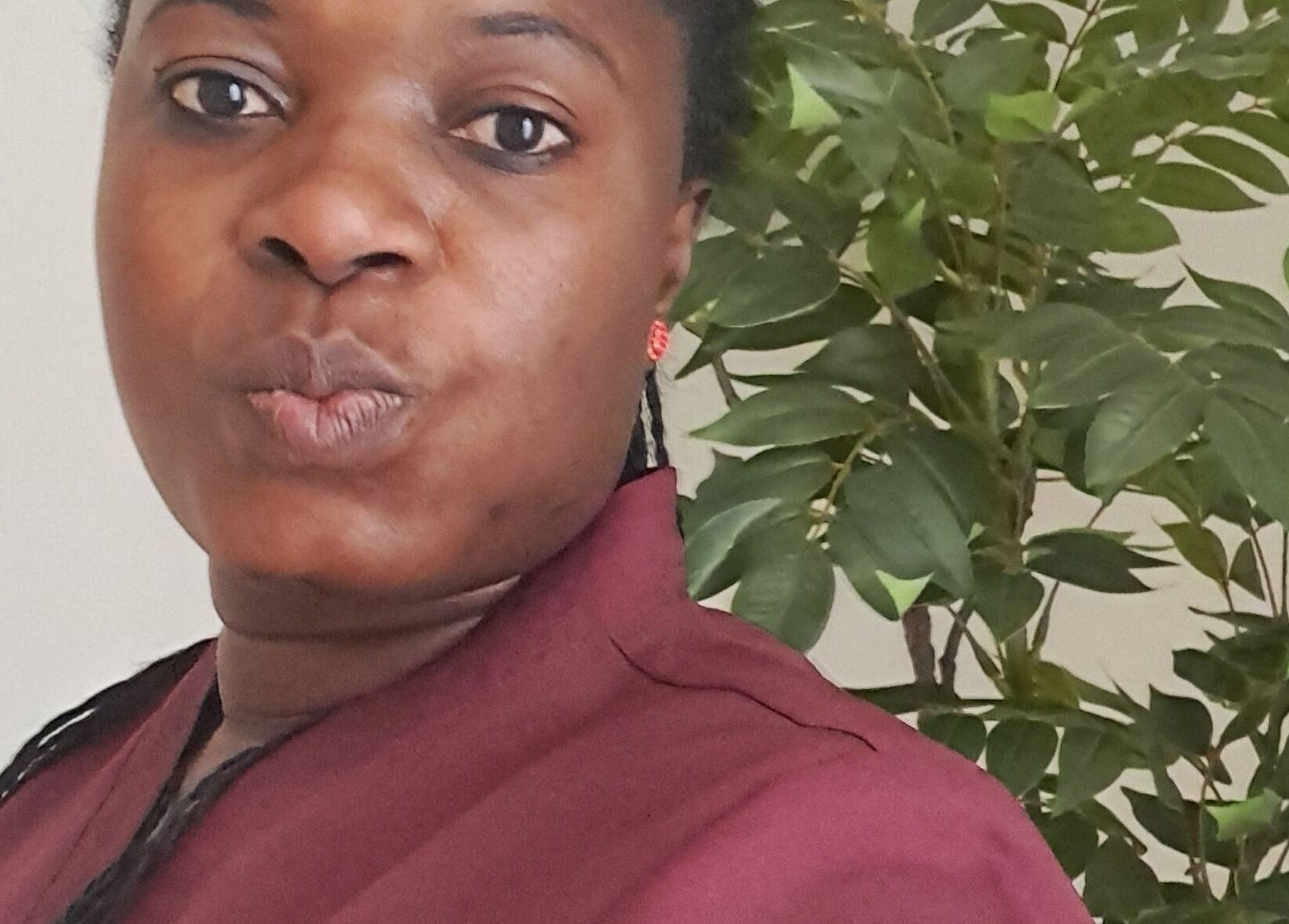 Therapist at Mariam Massage poses with natural backdrop in Muscat, OM.