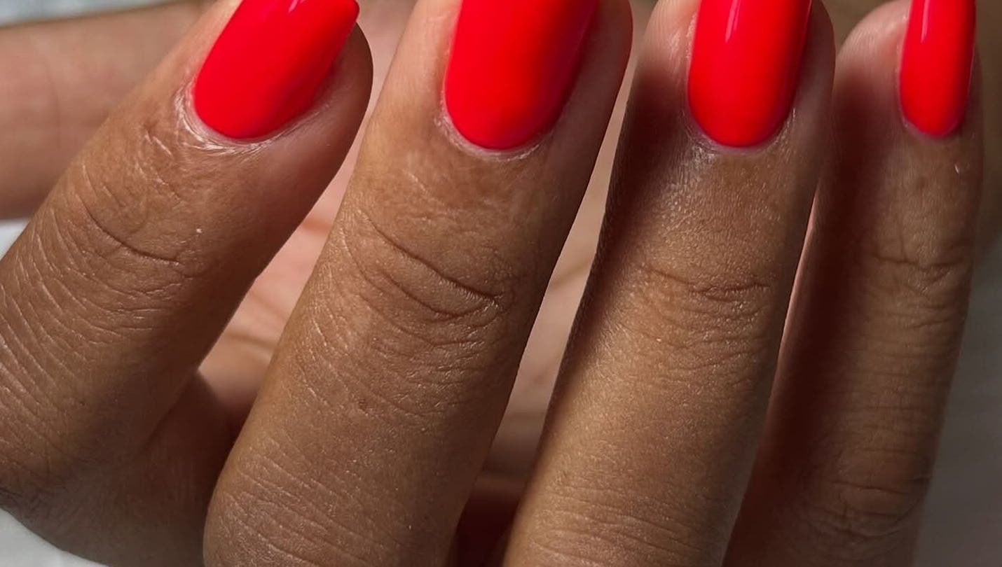 Vibrant red manicure at RANAKA BEAUTY SALON, Cape Town, Western Cape, ZA. Perfectly groomed nails.