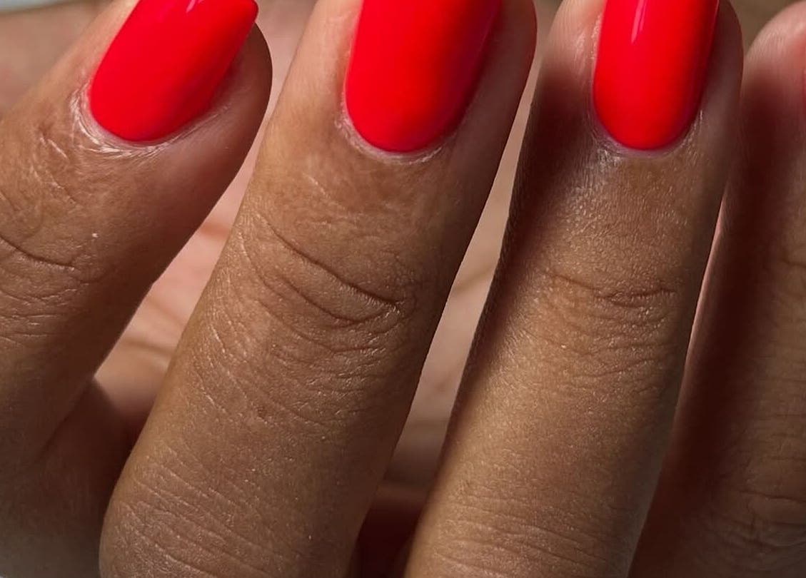 Vibrant red manicure at RANAKA BEAUTY SALON, Cape Town, Western Cape, ZA. Perfectly groomed nails.