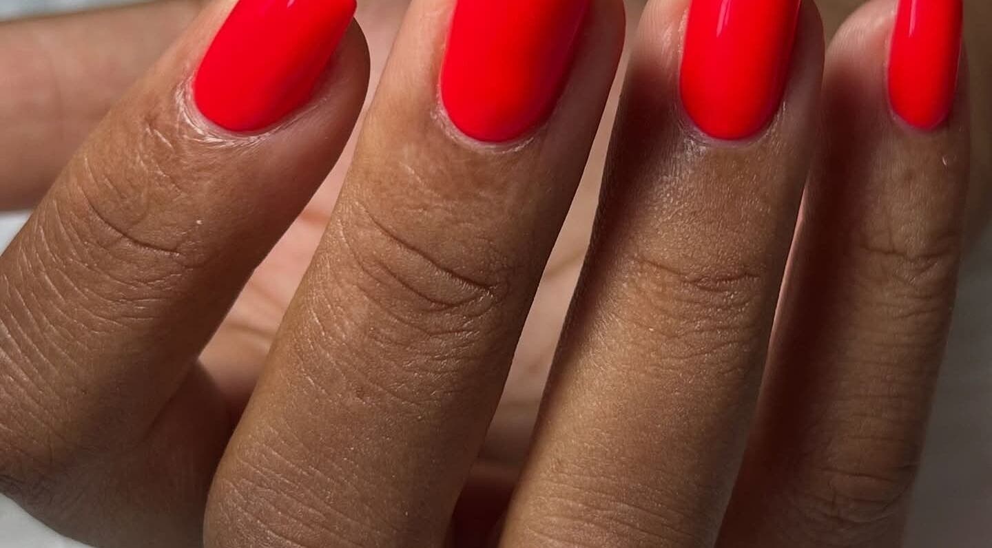Vibrant red manicure at RANAKA BEAUTY SALON, Cape Town, Western Cape, ZA. Perfectly groomed nails.