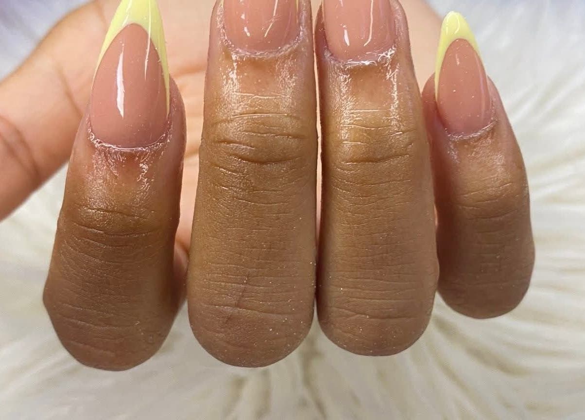 Stylish manicure with nude and yellow tips at RANAKA BEAUTY SALON, Cape Town, Western Cape, ZA.