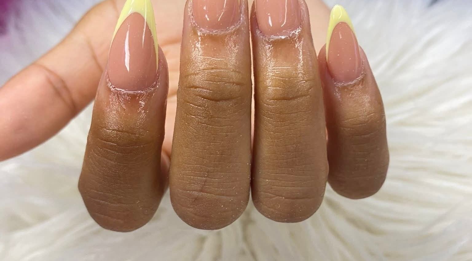 Stylish manicure with nude and yellow tips at RANAKA BEAUTY SALON, Cape Town, Western Cape, ZA.