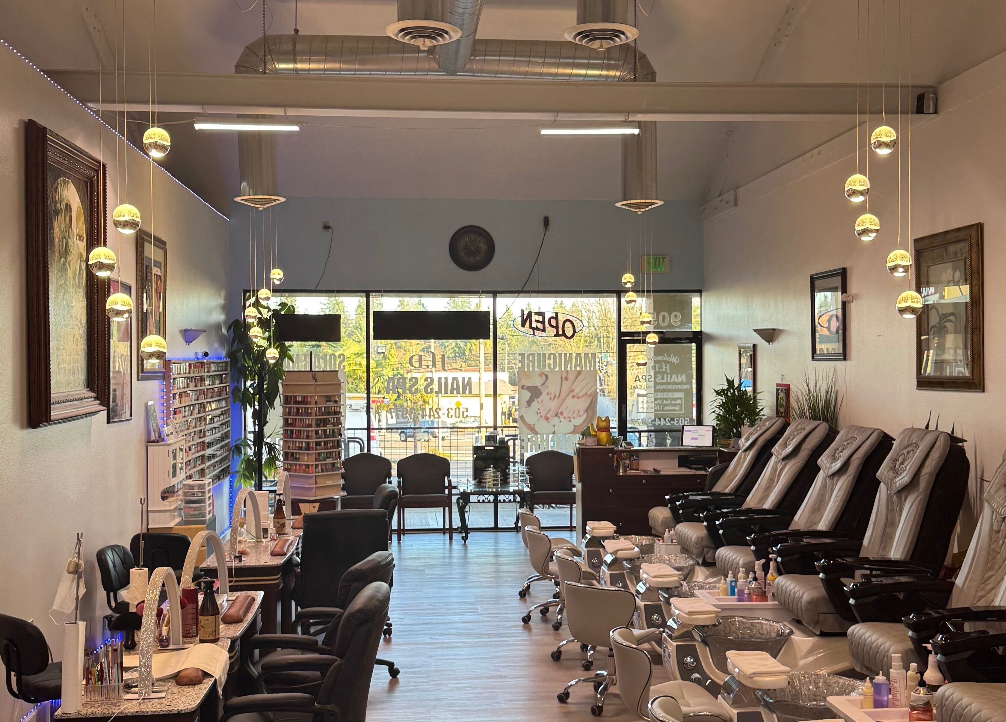 Elegant interior of HD Nails in Portland, Oregon, US with luxurious pedicure chairs and modern lighting.