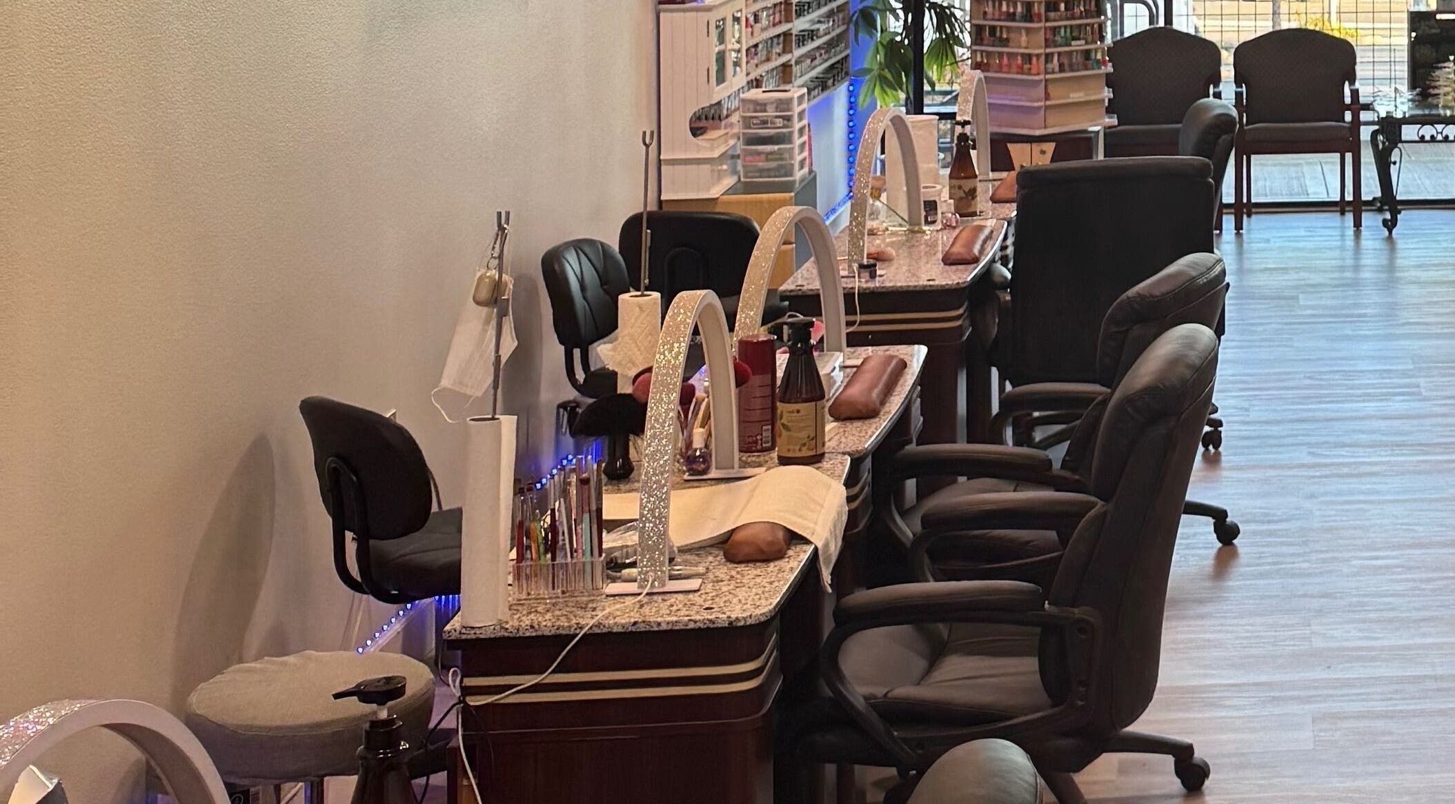 Elegant nail stations at HD Nails, Portland, Oregon, US, featuring modern chairs and polish displays.