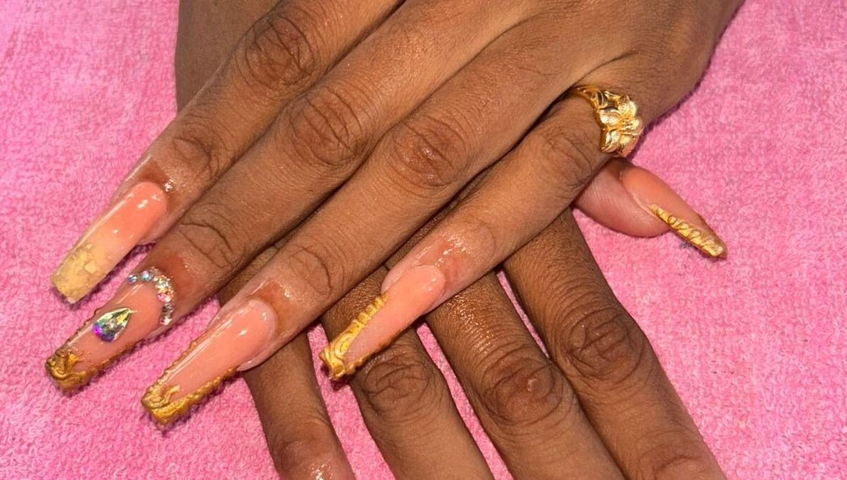 Elegant golden-accented nails at Creative Theia, Georgetown, Demerara-Mahaica, GY. Perfect for a stylish look.